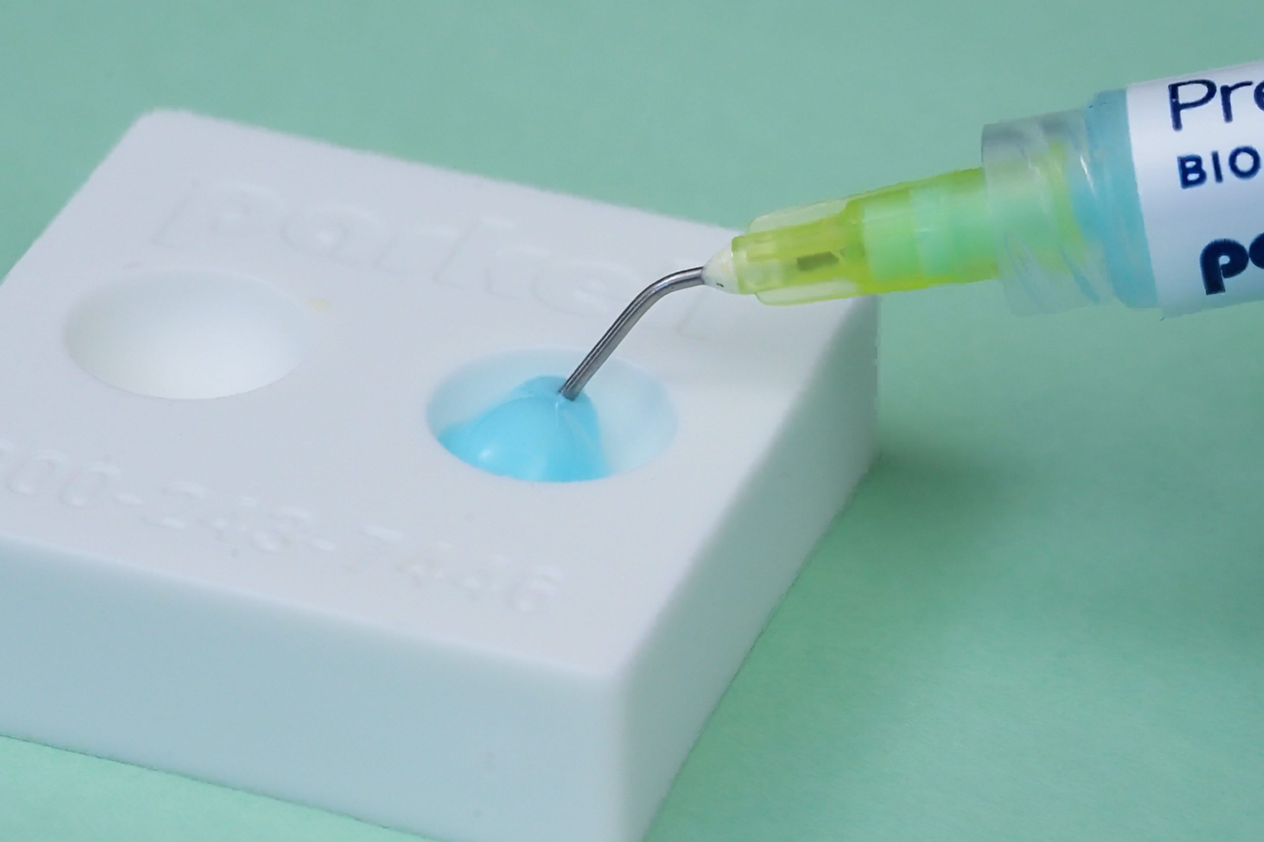Predicta Bioactive Desensitizer, a desensitizing gel for teeth, being dispensed from the syringe into the mixing well for clinical application
